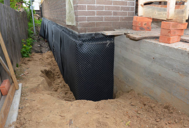 Happy homeowners after waterproofing job in Lannon